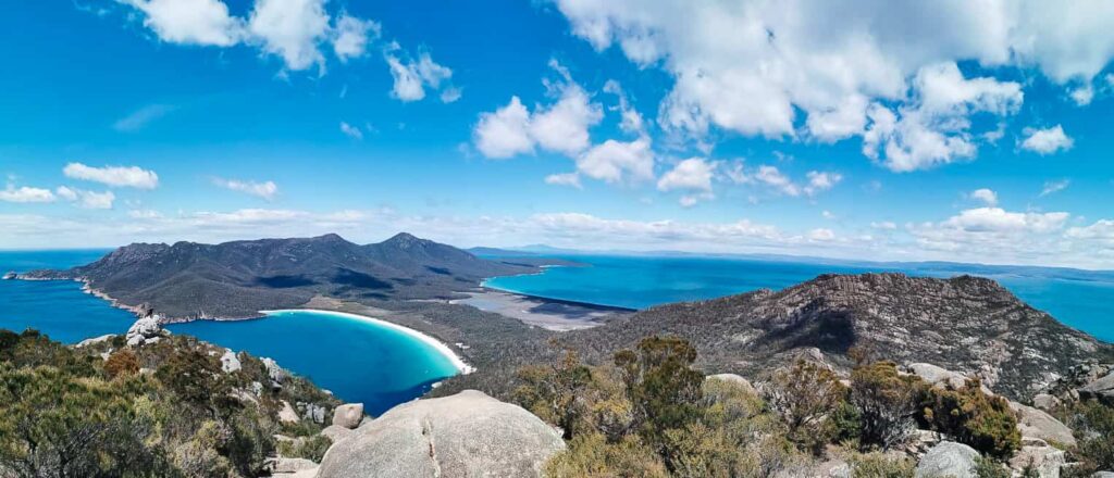 view of wine glass bay and coles bay from the summit of mount amos