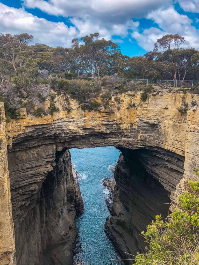 granite rocks creating a natural bridge called tasmans arch