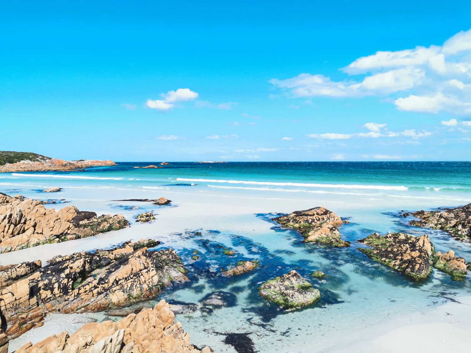 turquoise clear blue water of Binalong bay with the beautiful white sand beach on the Tasmanian road trip